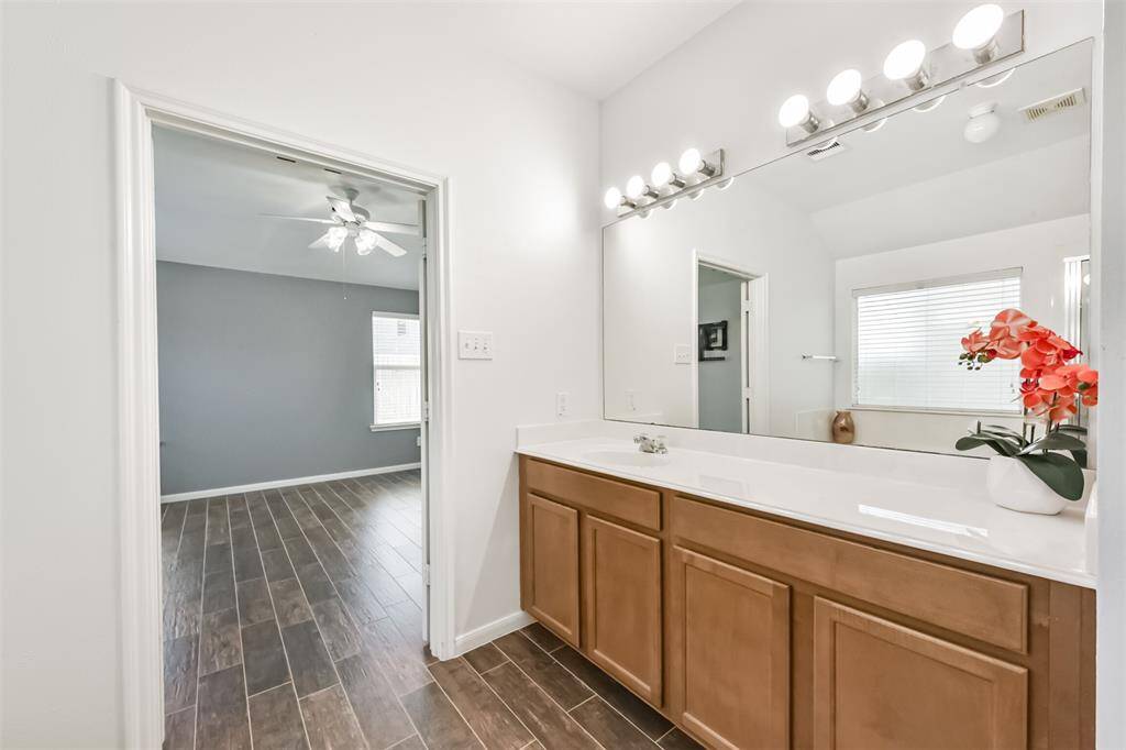 A spacious primary bathroom featuring ample cabinet storage.