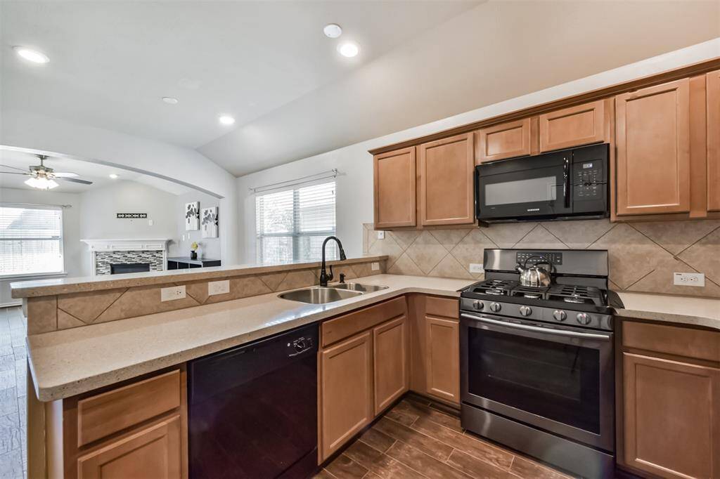View from the kitchen into the dining area and living room. Cute bar top that's great for entertaining!