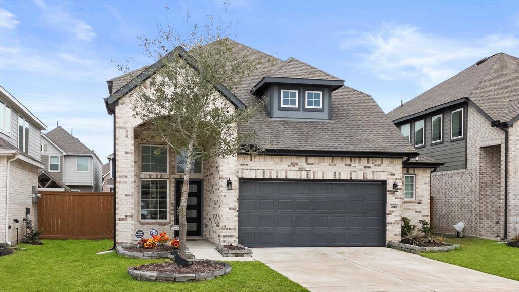 Approaching the front door you will see the brick elevation, lovely landscaping & front porch.