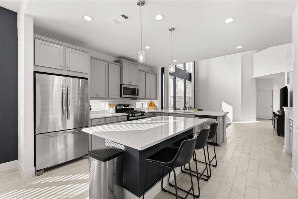 Sleek island that not only provides additional counter space but serves as casual gathering spot.