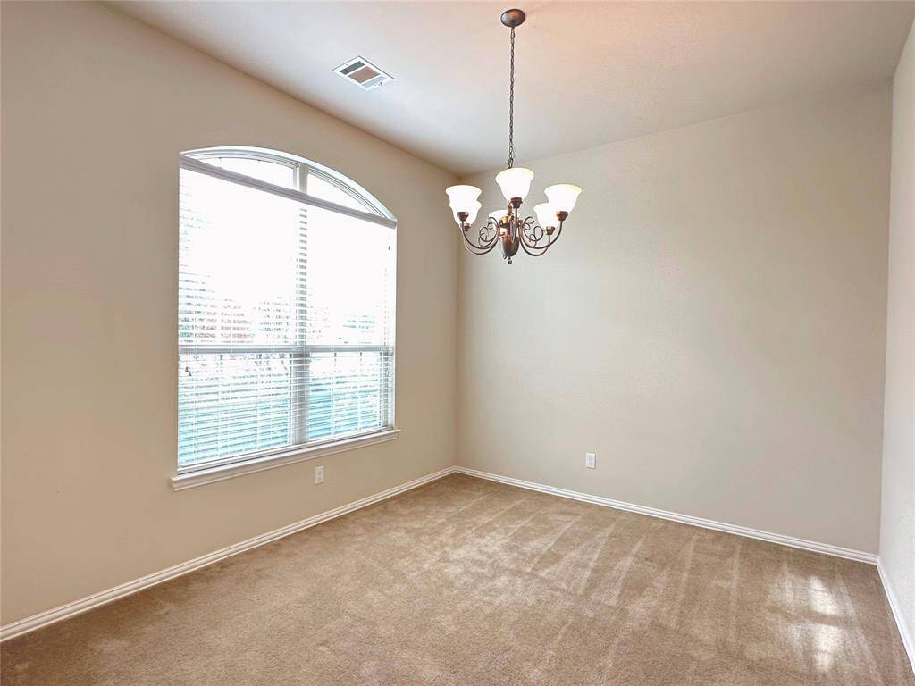 Formal dining with a large window invites abundant natural light.