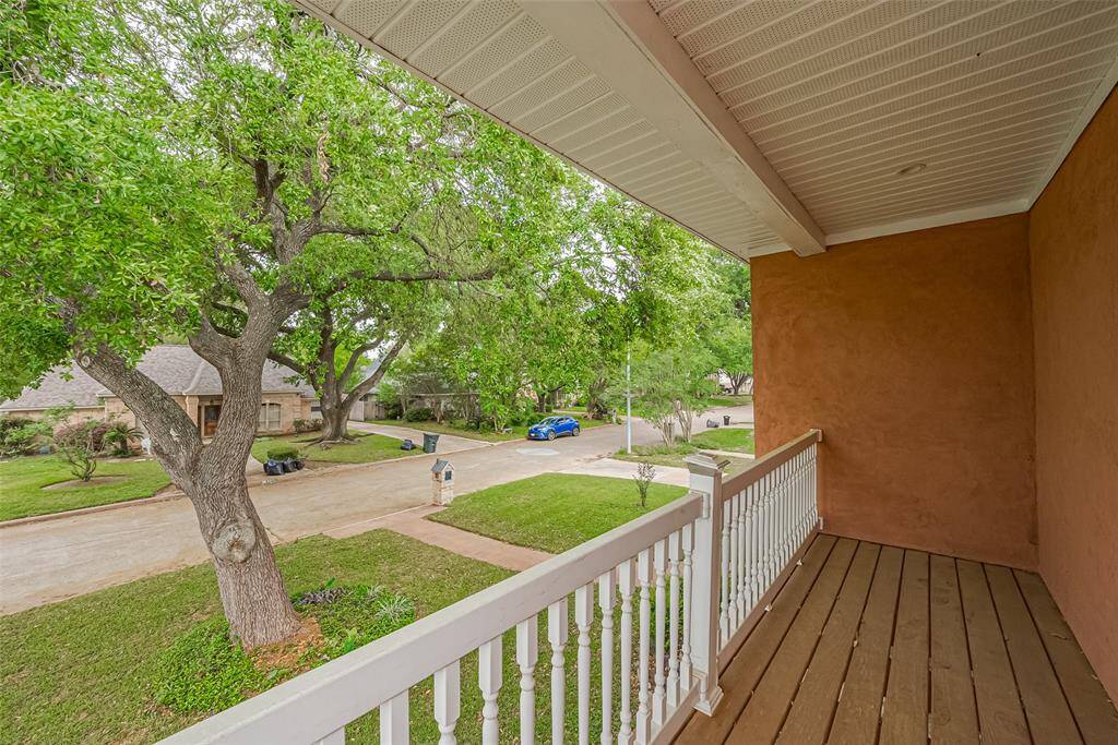 Enjoy your morning coffee or an evening breeze on this upper-level balcony. With a serene view of the neighborhood and leafy mature trees, it's the perfect spot for relaxing or catching up with neighbors. There are balconies/patio off of each master bedroom.