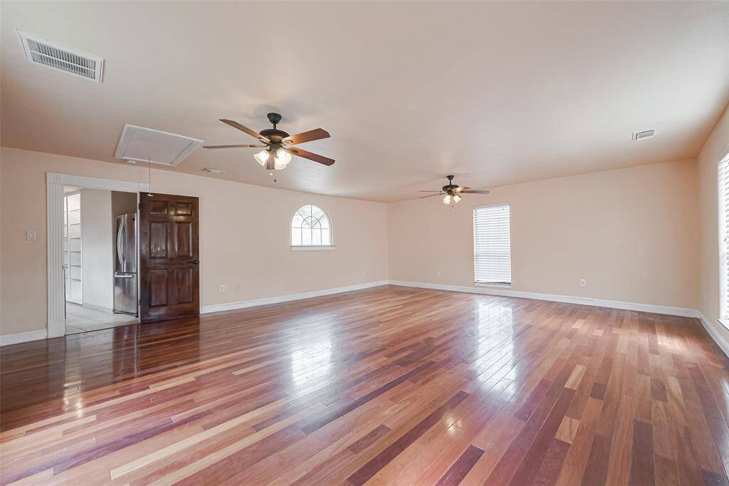 This large open room past the kitchen could be a 5th bedroom, game room, media room or add a pool table for extra fun.