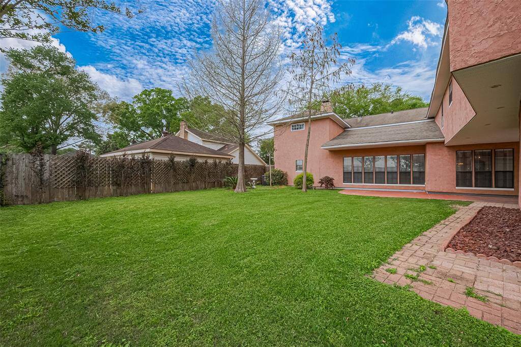 The oversized backyard offers ample green space for gatherings, gardening, or future additions. With mature landscaping and plenty of privacy, this outdoor oasis is ready for playtime or peaceful weekends.