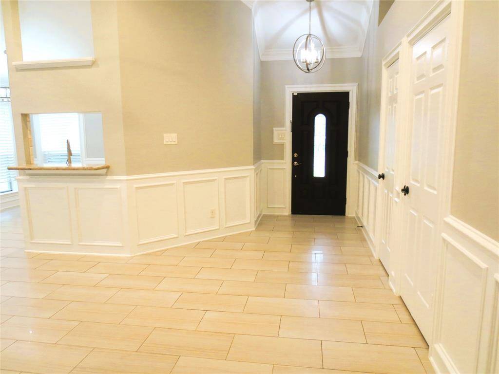 This charming single-story home features a welcoming front yard with a well-maintained lawn. It has a two-car garage, a covered entryway, and a simple, clean exterior design suitable for comfortable living.