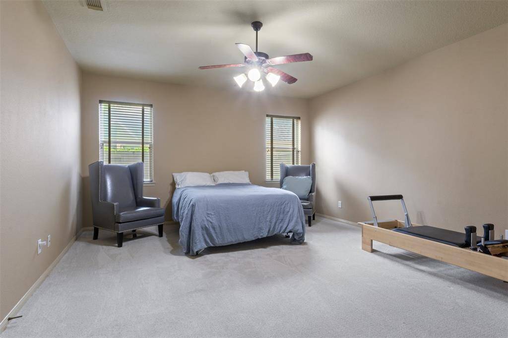 Designed as a media room for immersive movie nights and game-day gatherings, this flexible space is currently configured as a spare bedroom. Its generous proportions and soft carpeting offer endless potential to suit your lifestyle needs.