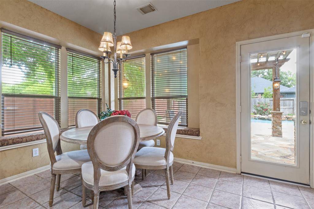 Enjoy peaceful mornings or casual meals in the light-filled breakfast nook, surrounded by a wall of windows overlooking your private backyard oasis. Just steps away from the patio and pool, this space offers a serene transition between indoor dining and outdoor entertaining.