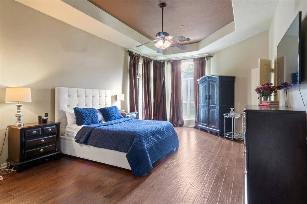 Retreat to the spacious primary bedroom, where hardwood floors, soaring ceilings, and soft natural light create a calm, luxurious ambiance. A private haven for rest and rejuvenation, this suite offers the perfect start and end to each day.