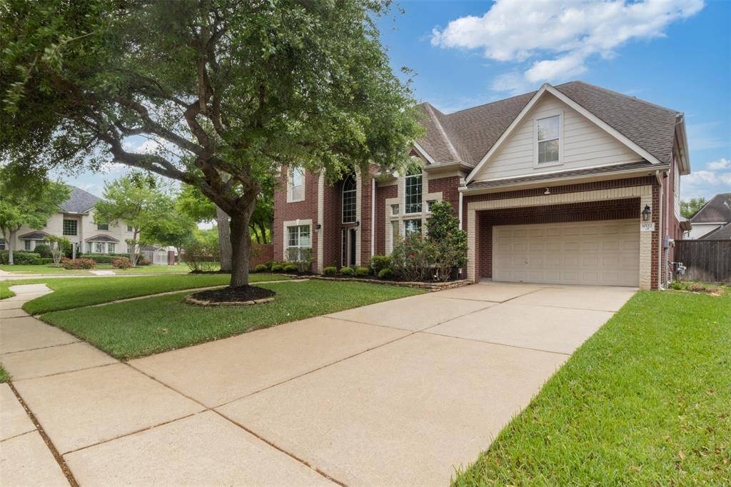 Spacious double-wide driveway and two-car garage offer everyday convenience and plenty of room for guests. The manicured front lawn and mature shade tree enhance curb appeal while setting the scene for a relaxed, welcoming lifestyle in Greatwood.