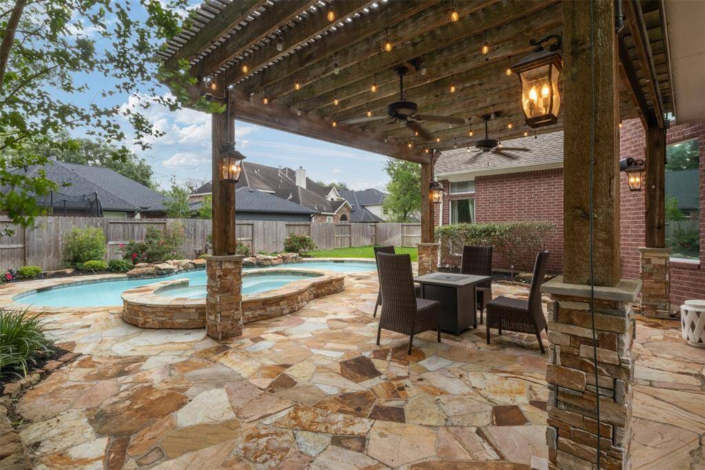 Unwind under the custom pergola adorned with café lighting, overlooking your private heated pool and spa—an entertainer’s dream and the perfect setting for year-round outdoor living.