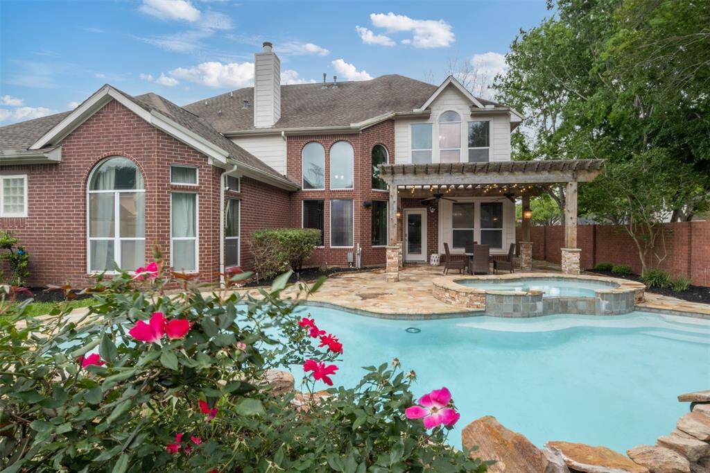 Welcome to your own private resort—this backyard oasis features a sparkling pool and spa, framed by lush landscaping and elegant architecture, offering the perfect blend of luxury and tranquility.