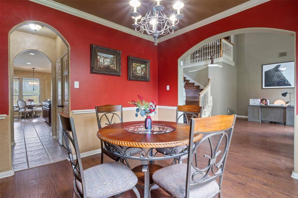 Host unforgettable dinners in the formal dining room, where bold accent walls and elegant architectural details create a lively yet sophisticated setting. With effortless flow to the kitchen and main living areas, this space is perfect for gathering and celebration.