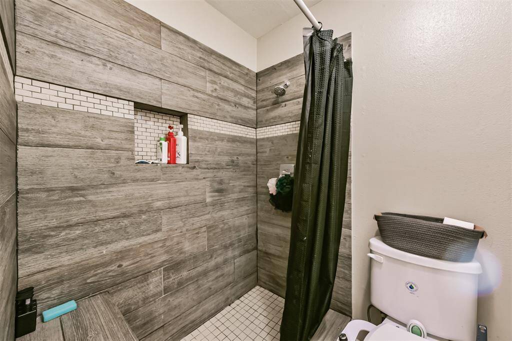 The standing shower in the full bathroom has updated tile surround.