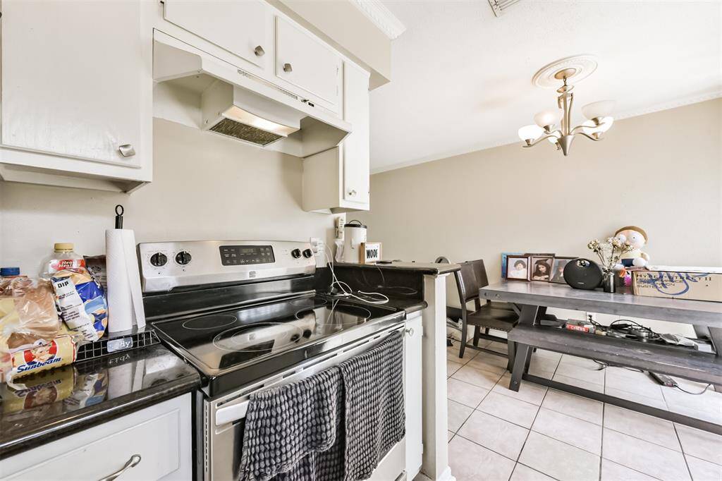 There is an electric oven/range will vent hood.