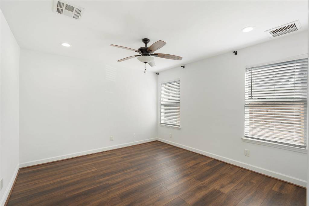 Two additional bedrooms provide versatility, perfect for a home office or guest room.