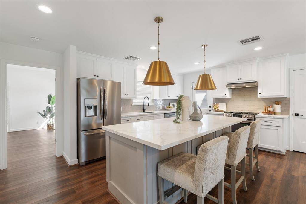 This spacious island is a chef's dream, offering plenty of prep space and additional room for seating.