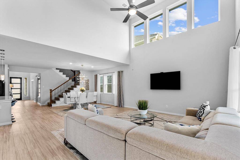 Open living and dining with high ceilings.