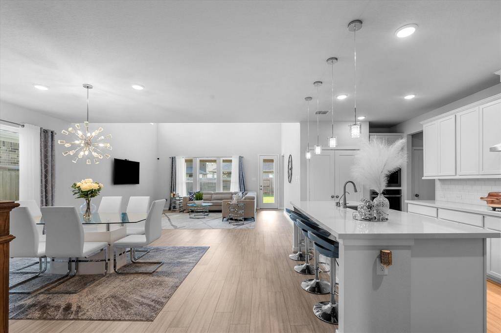 Open living/dining with updated fixtures.