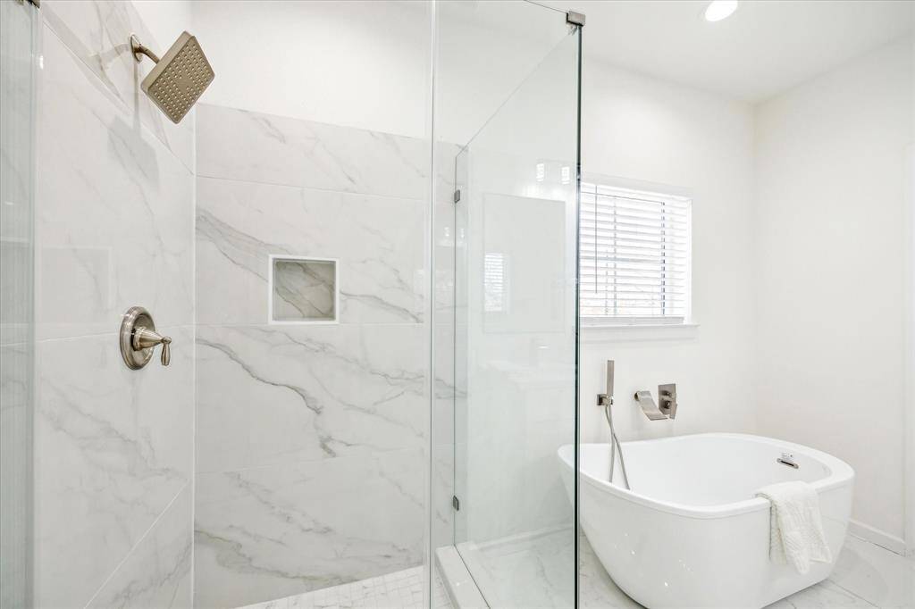 Primary bathroom suite with separate tub and shower and double vanity