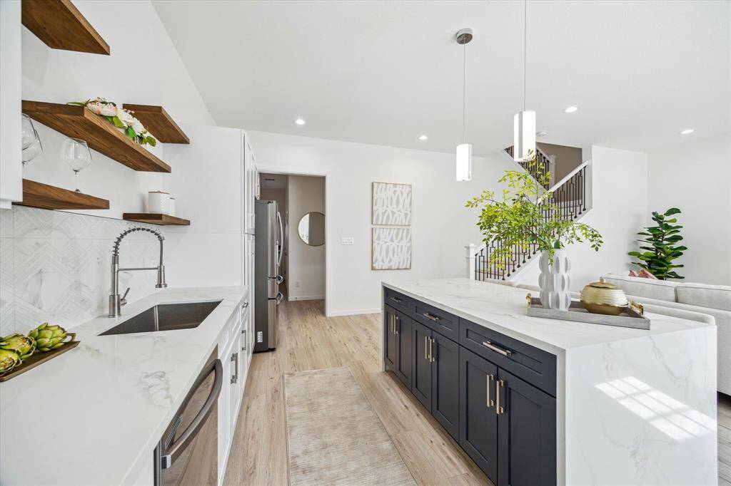 Gourmet kitchen with stainless steel appliances, quartz countertops, and ample storage
