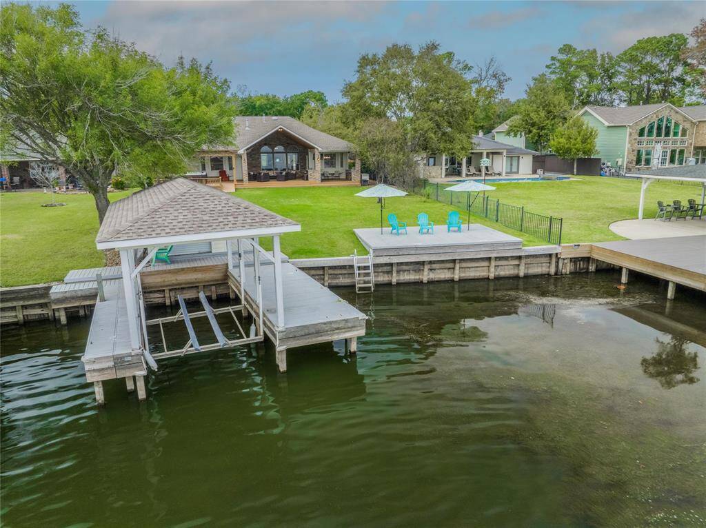 Lakefront with 70+/- ft of bulkhead! A dock and a boat lift with a boat house!