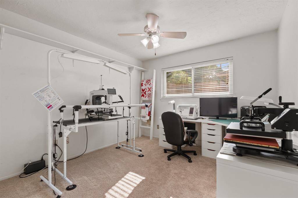 This large bright room is set up as a crafting or sewing space, a large window for natural light. Ideal for childs room, hobbyists or a home office.