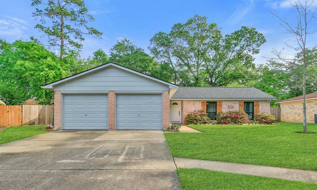 Charming single-story home with a two-car garage, brick exterior, and well-maintained lawn. Features a welcoming front entrance, neatly landscaped garden beds, and mature trees providing shade and privacy.