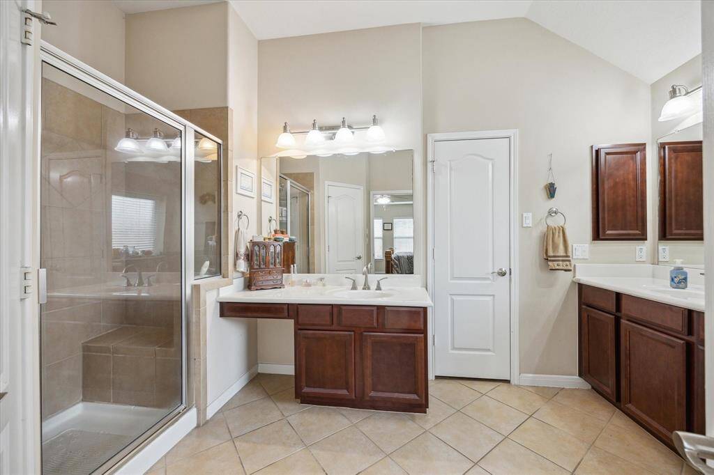 Primary bathroom has two full vanities with extra storage space, built in medicine cabinet, separate shower, water closet and tub.