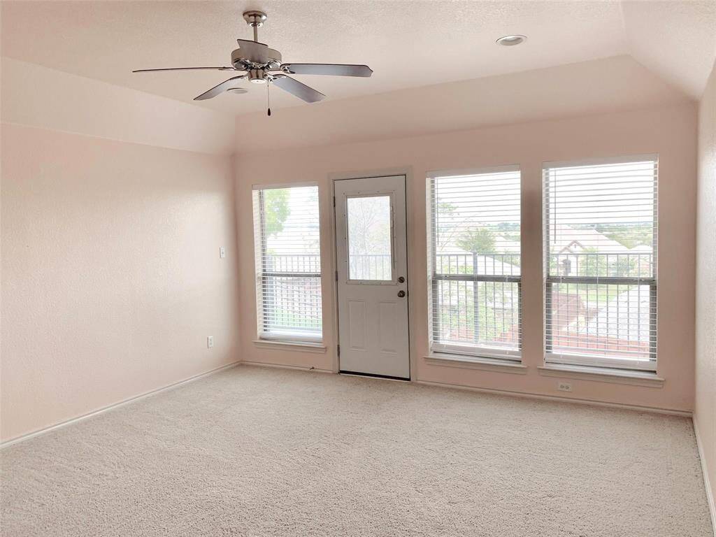 Welcome to the upstairs game room—perfect for a second living area, playroom, or home office. This inviting space features an open layout & versatile design, with access to a private balcony that offers scenic views & a quiet place to unwind.