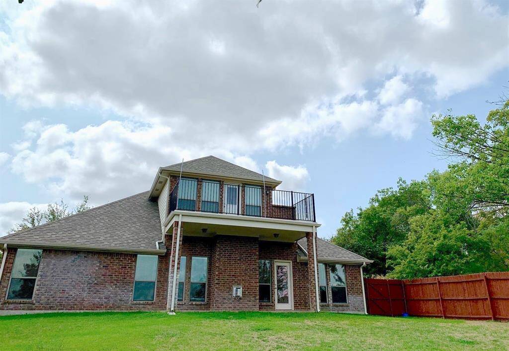 The backyard boasts an open and spacious layout, perfect for outdoor entertaining, and includes a covered patio/deck that provides a shaded retreat for relaxing or dining al fresco.