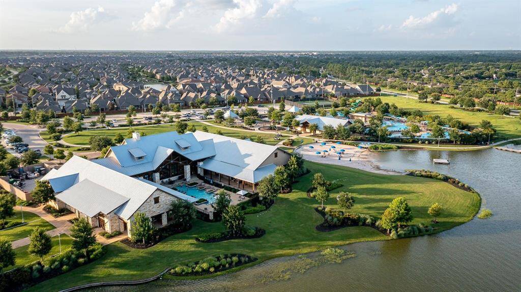 The Towne Lake amenities will surely impress. This is an aerial view of the main Lake House with a marina, workout facility, adult pool, lazy river, tennis courts and more!