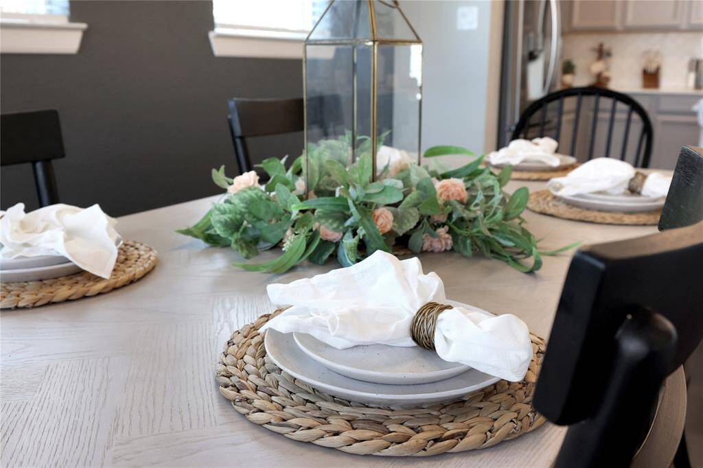 the dining area is complemented by neutral tones creating a warm and inviting atmosphere.
