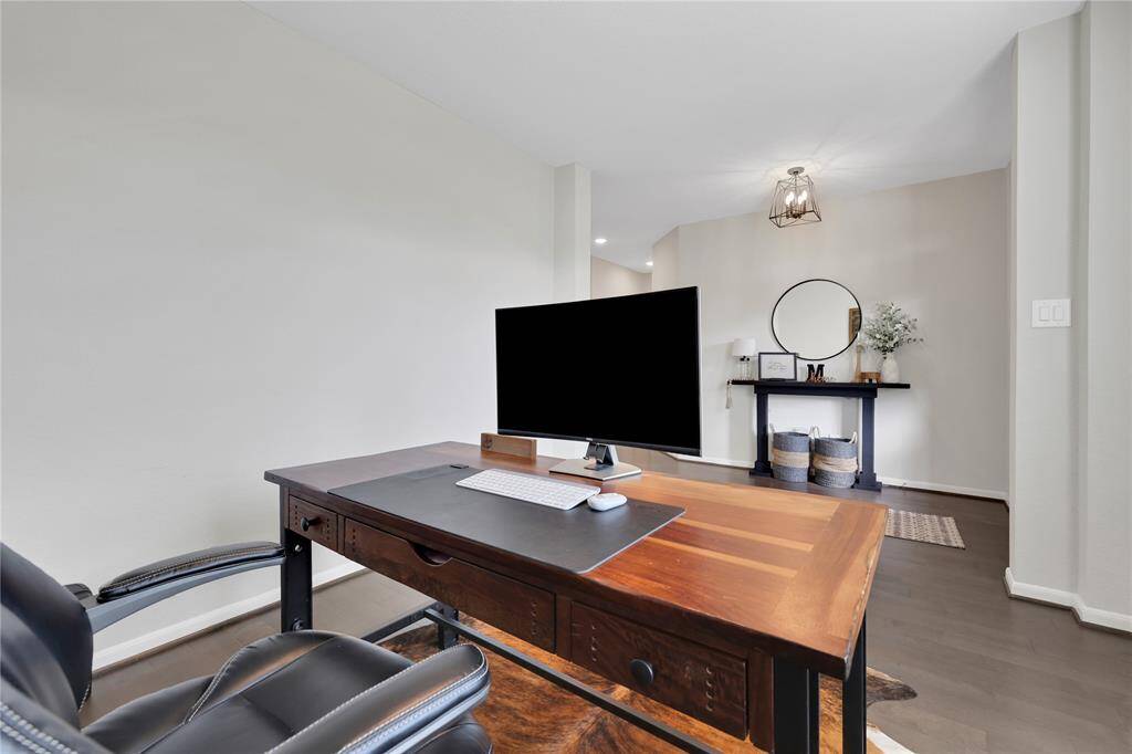 The room features neutral wall colors and hardwood flooring, creating a warm and inviting workspace.