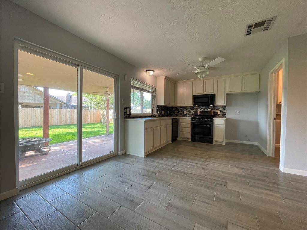 Views of the kitchen and sliding glass door for access to the backyard.