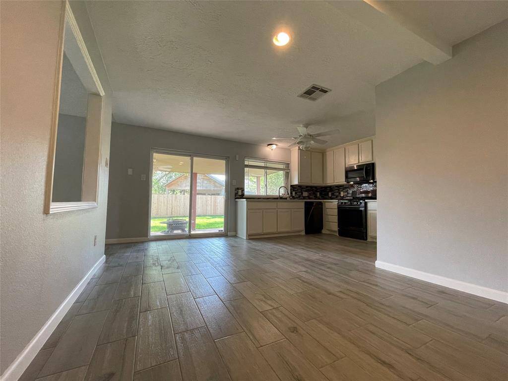 Views of the kitchen and  sliding glass door which leads to the backyard.