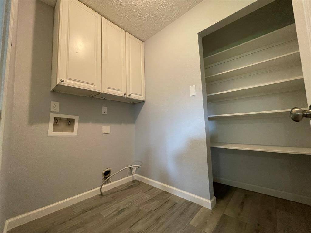 Utility room and pantry are located conveniently off the kitchen. Gas dryer hookups, washer hook-ups and cabinets above the washer and dryer area.