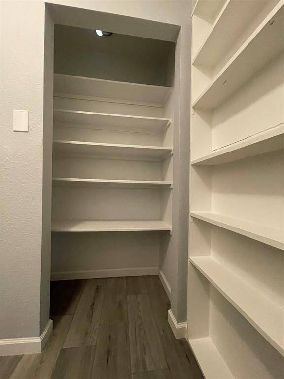 Walk-in pantry/utility room combo offers plenty of room for storage and easy access to stored goods.