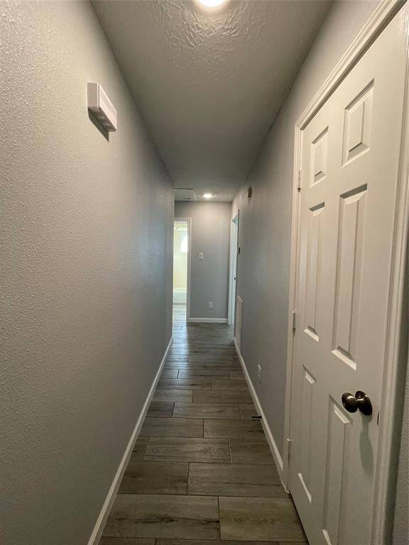 Hallway leading to secondary bedrooms and bath includes a coat closet conveniently located near the entry to the home.