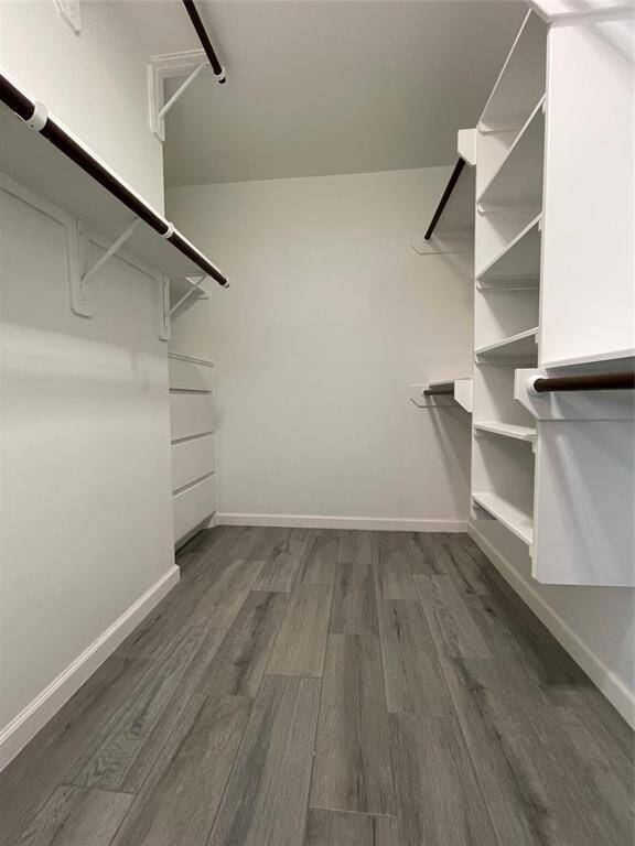 Primary closet features built-ins, including a chest of drawers.