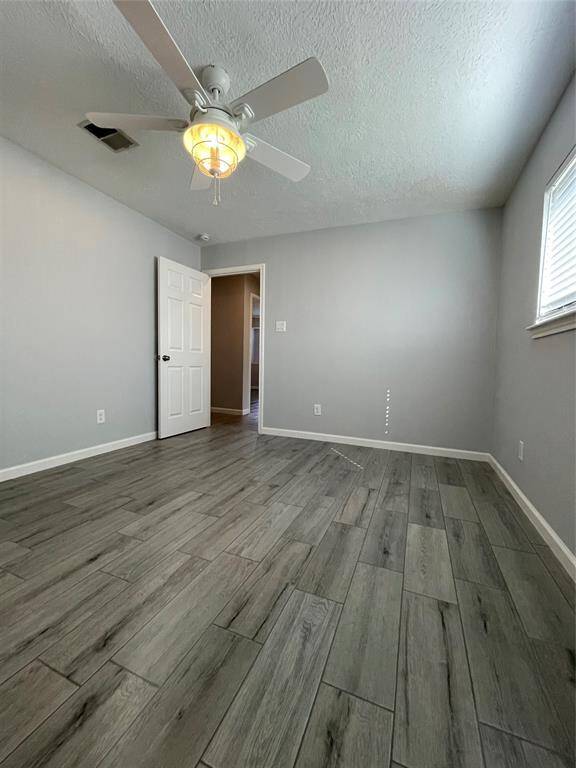 Alternate view of primary bedroom and entry door.
