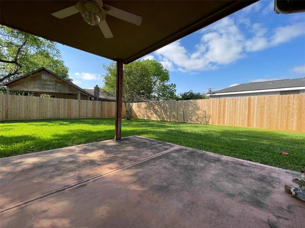 Alternate view of backyard.  New fencing on the right side and back for the house.