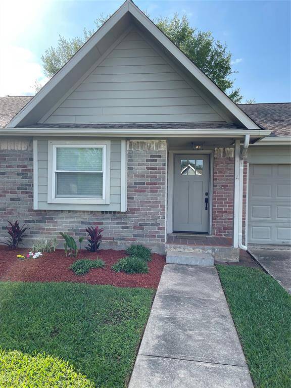 Sidewalk leads from the driveway to the front entry.