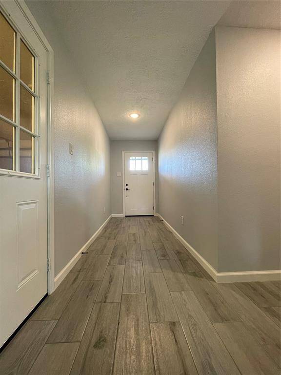 Long foyer draws visitors toward the open family room with vaulted ceilings.