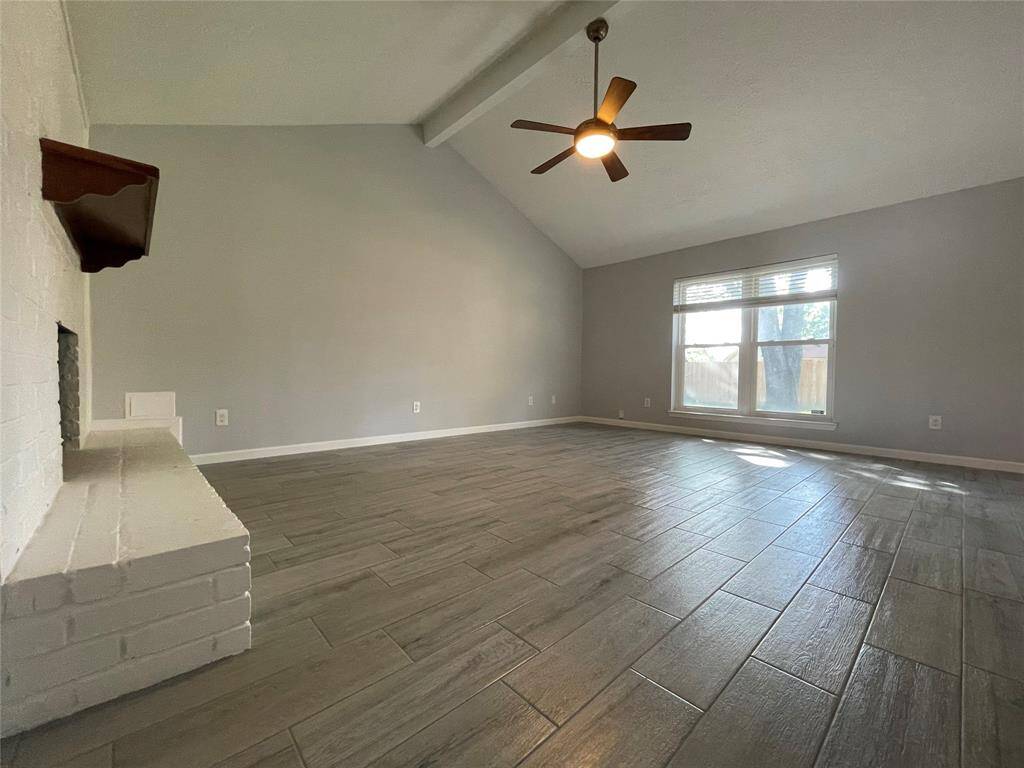 Family room features vaulted ceilings, fireplace and an abundance of natural light from the back of the home.