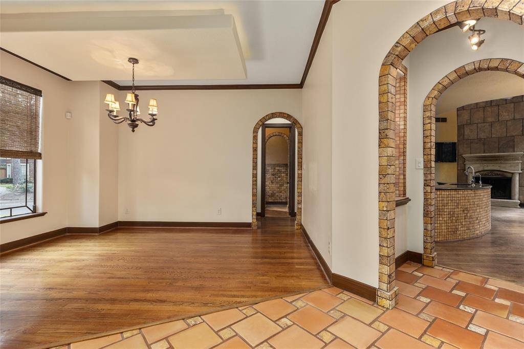 The formal dining room has a custom chandelier and beautiful windows again