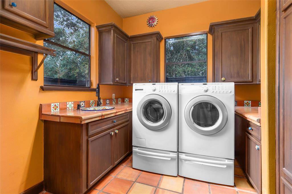 The laundry room is spacious with more custom cabinetry