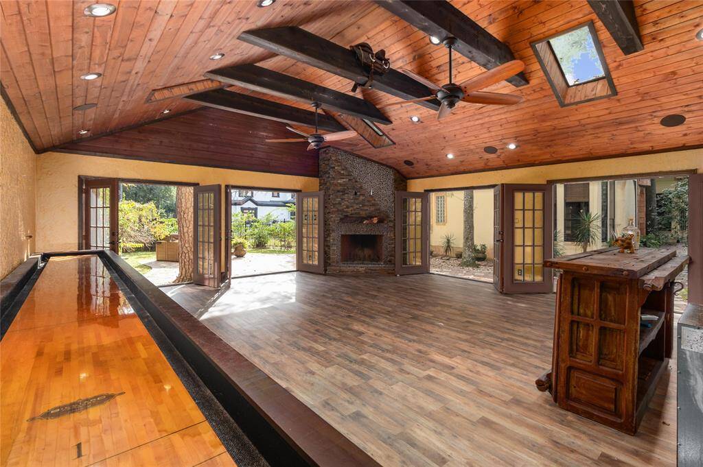And french doors surrounding this approximately 624 sq ft room with a wood burning fireplace.