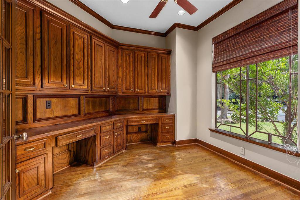 Work from home in this office with rich wood custom cabinets and desk.