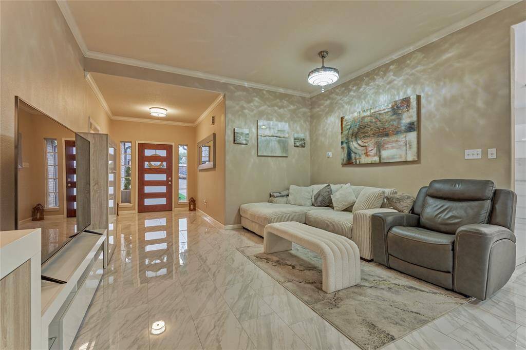 The modern wood and glass door is a true focal point in the foyer.