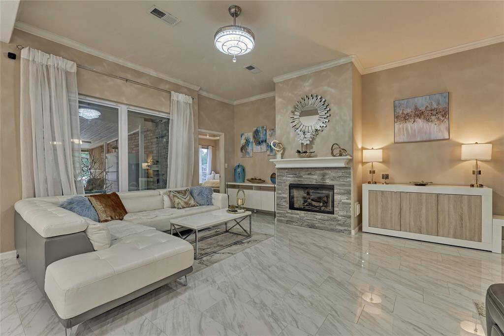 The family room is a calming place for gathering and enjoying intimate conversation. A stacked-stone fireplace for fall and winter evenings provide a cozy ambiance.